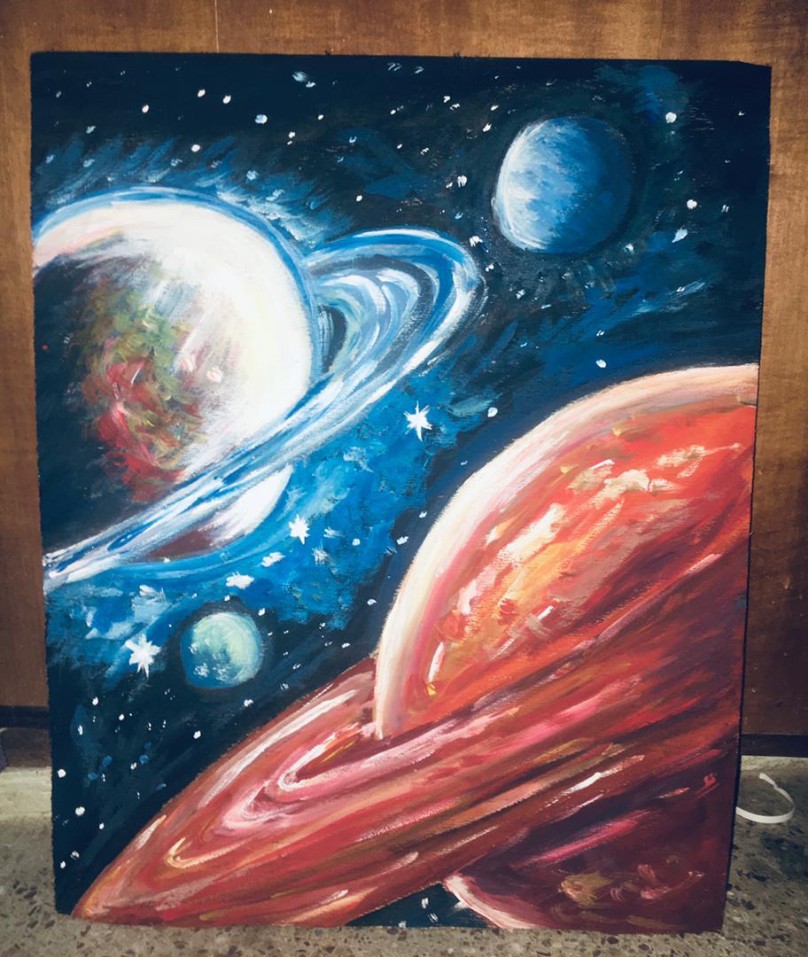 A ringed planet and a swelling red world drifting among stars and smaller moons in deep blue space