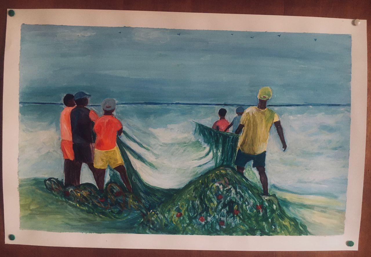 Fishermen hauling a green net from the surf on a Cape Coast beach